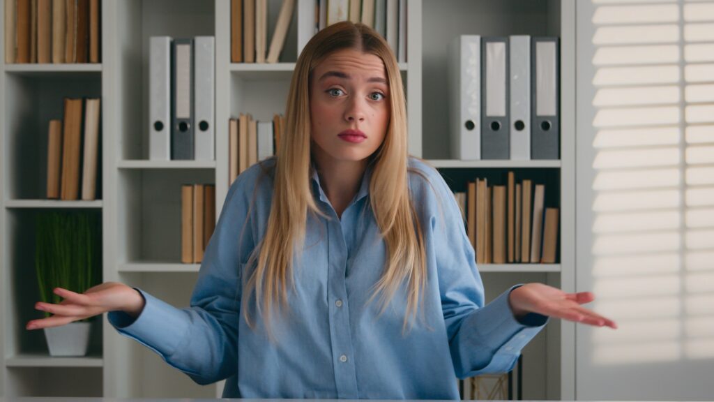Academic student girl in library shrug unsure don't know Caucasian woman shrugging shoulders