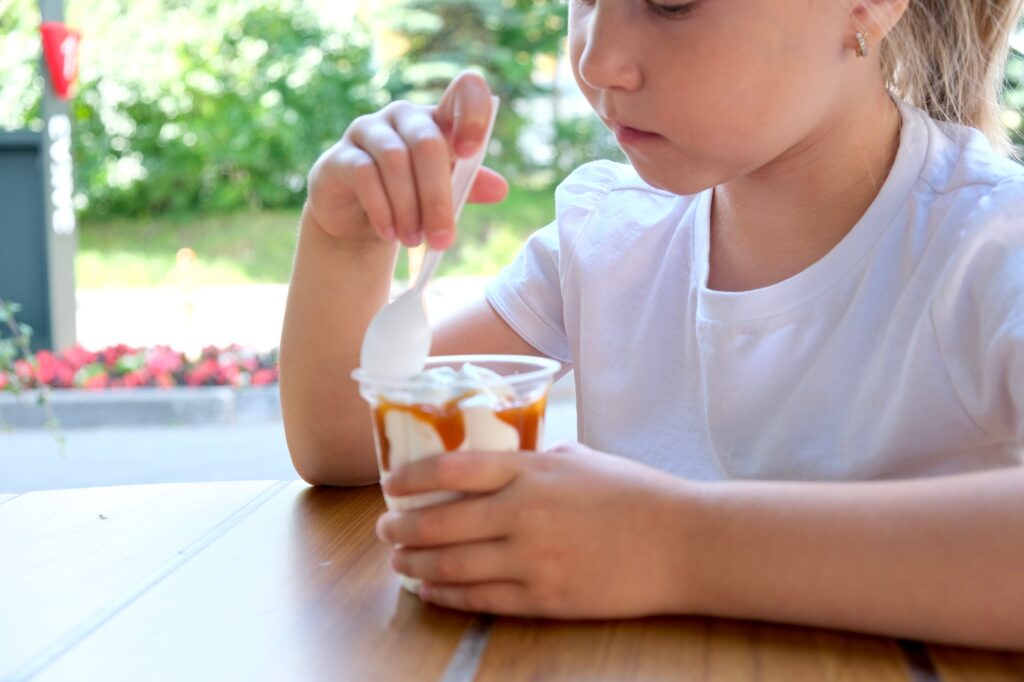 Child eating ice cream on the street