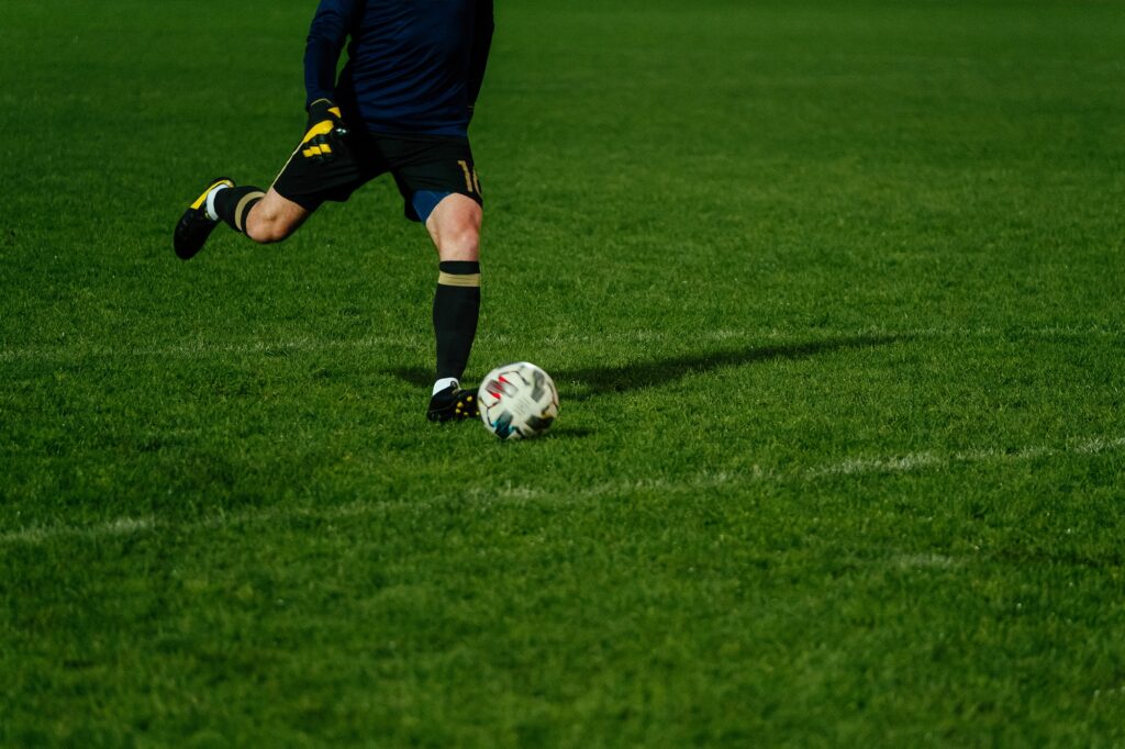 goalkeeper kick ball during football match