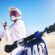 Sports, cycling and man stretching on motorbike on sand for adrenaline, adventure and freedom in de