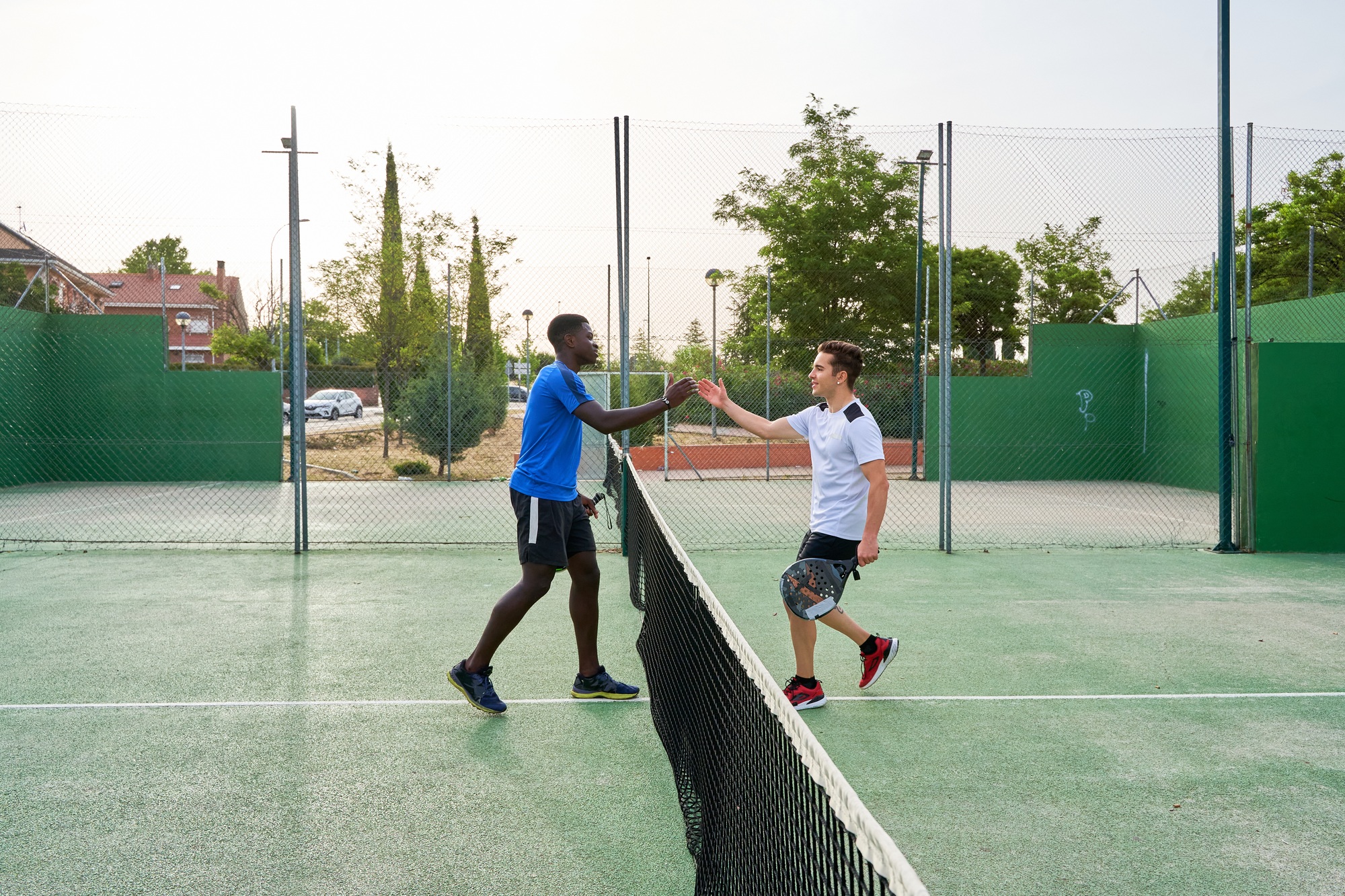 two paddle players greet each other at the end of the game