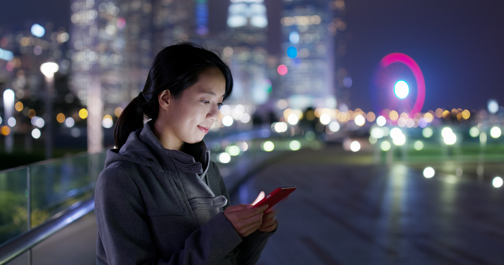 Woman send sms on cellphone at night