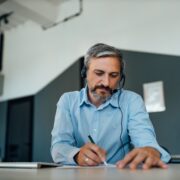 Writing an letter to his company.